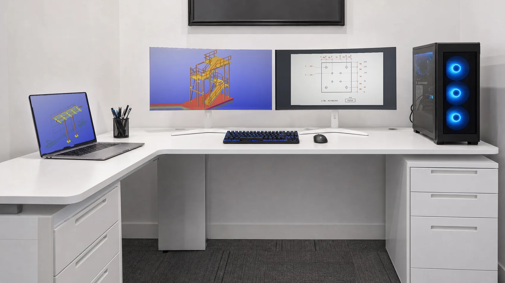 A two monitor CAD workstation, the Quick Draft office: two curved monitors with an Advance Steel model and the F1010 plate drawing, and a canopy model on the laptop